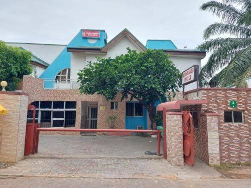 a building with a gas pump in front of it at Abuja Bays Garden Hotel Ltd in Mama