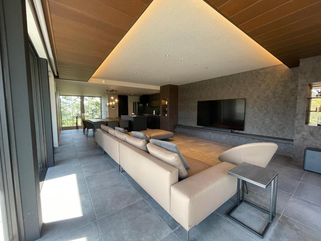 a living room with a couch and a television at Fuji Yamanakako Villa in Yamanakako