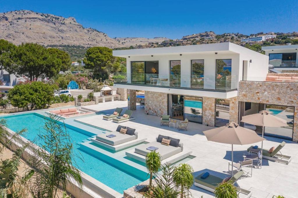 an aerial view of a villa with a swimming pool at Villa Pefkos Cove by Villa Plus in Pefki Rhodes
