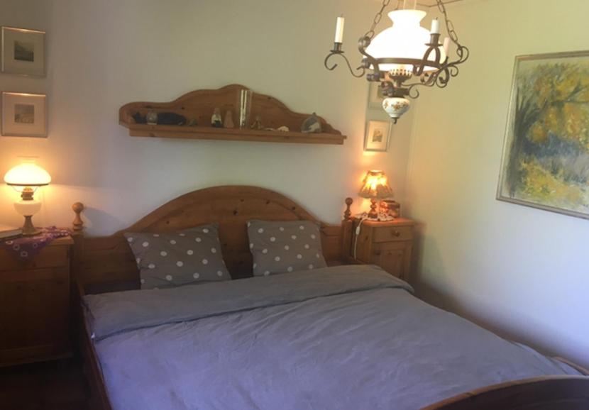 a bedroom with a bed with blue sheets and a lamp at Slussens Stay - Sea View in Slussen