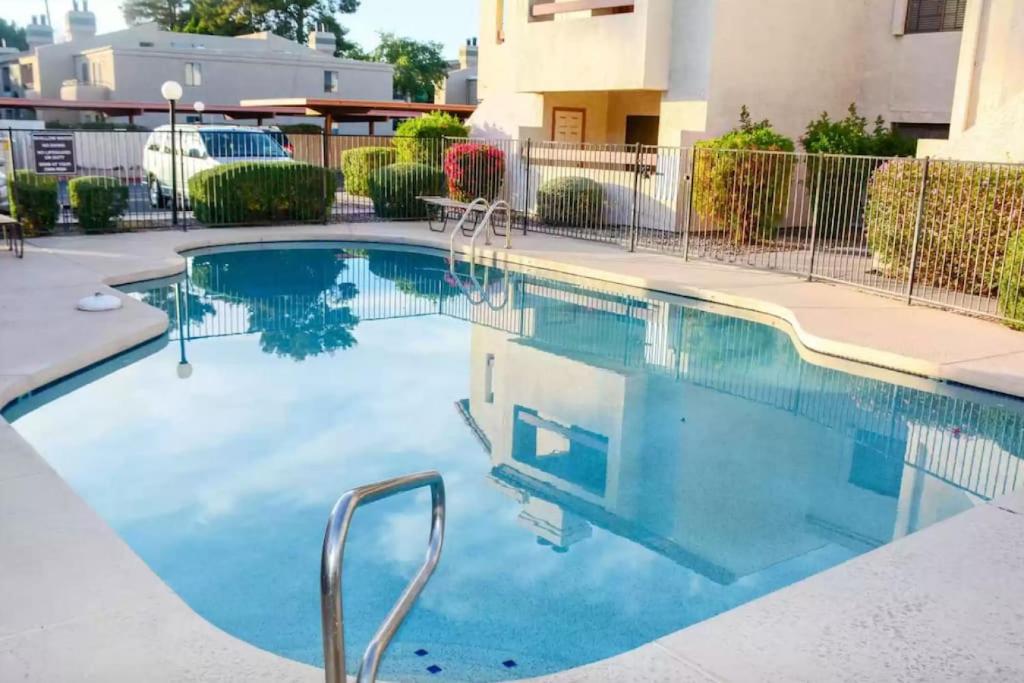 a swimming pool with blue water in a building at Old Town Southwest Style 2BR Condo with Pool and Hot Tub in Scottsdale