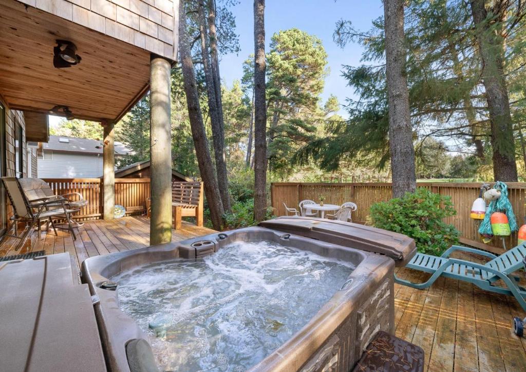 a hot tub on the deck of a house at Sea Dream MCA#398 in Manzanita