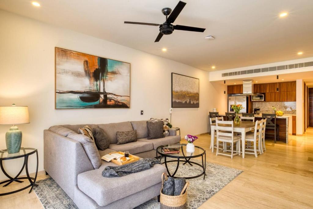 a living room with a couch and a table at Group Apt 13 16, no view, 3BR, 12 pax in Cabo San Lucas
