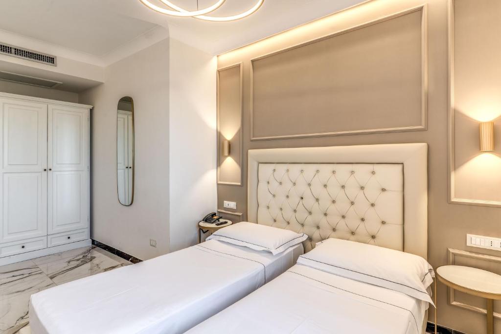 Łóżko lub łóżka w pokoju w obiekcie Hotel Castel Vecchio