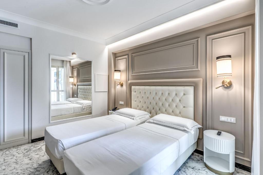 Łóżko lub łóżka w pokoju w obiekcie Hotel Castel Vecchio