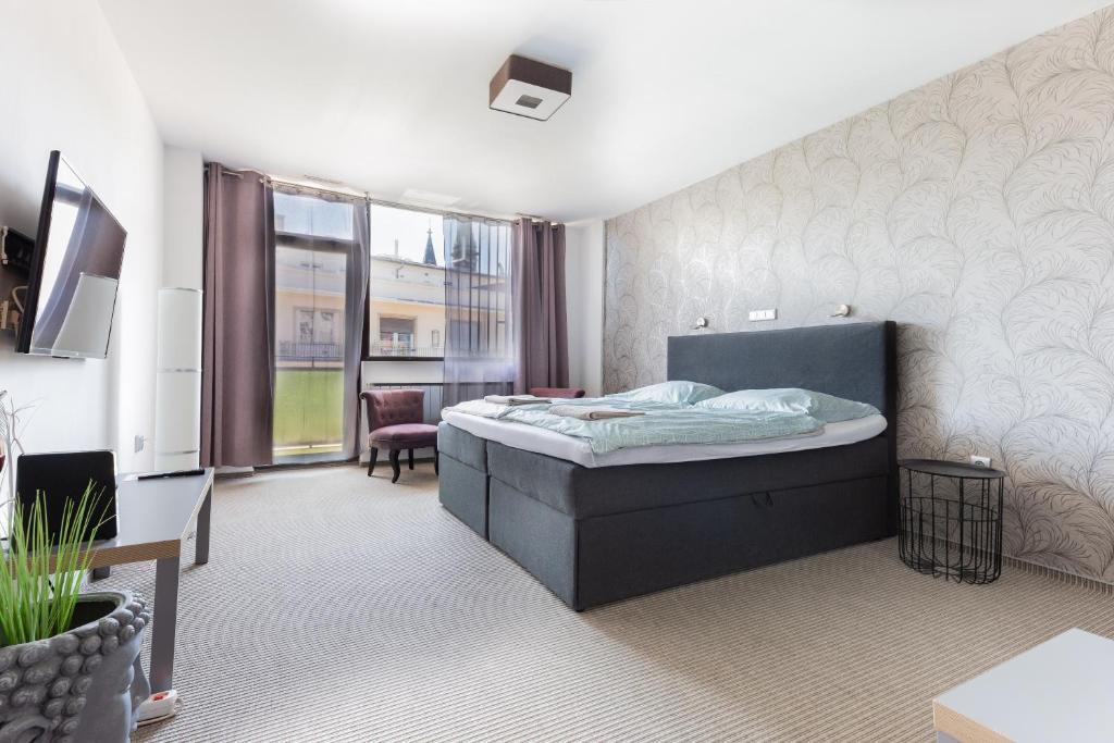 Postel nebo postele na pokoji v ubytování Prince apartment downtown