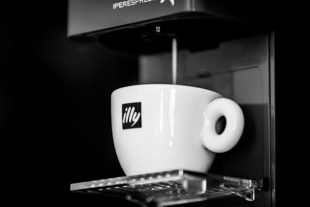 a coffee cup on a tray in a microwave at Carlton George Hotel in Glasgow