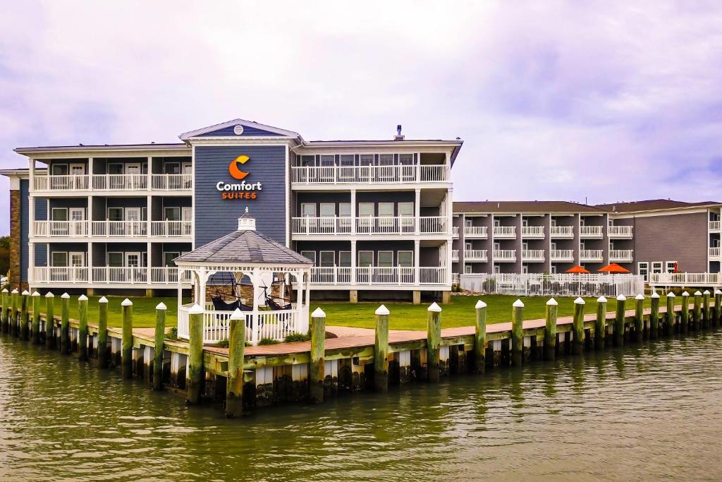 a hotel on the water with a dock at Comfort Suites Chincoteague Island Bayfront Resort in Chincoteague