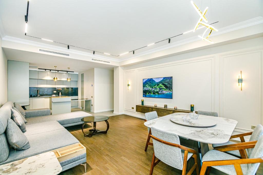a living room with a table and a couch at Megafun Apartment 3 Bedroom in Baku