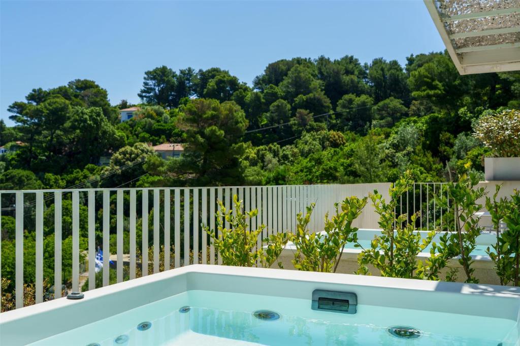 a hot tub on the balcony of a house at Radisson Resort Plaza Skiathos in Kanapitsa
