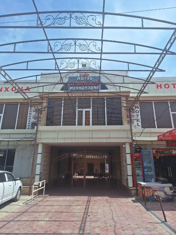 a building with a parking lot in front of it at Shohruh Hotel in Guliston