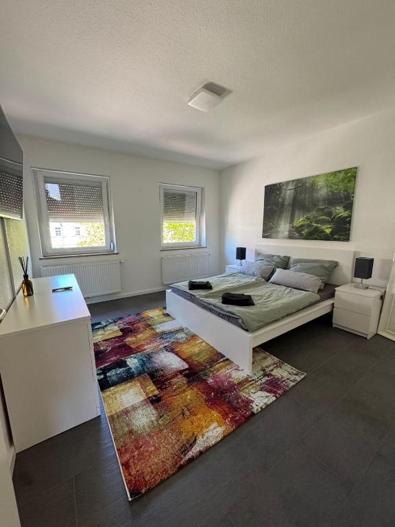 a bedroom with a bed and a rug at Modernes Zimmer am Campus 3 mit Gemeinschaftsbad in Villingen-Schwenningen