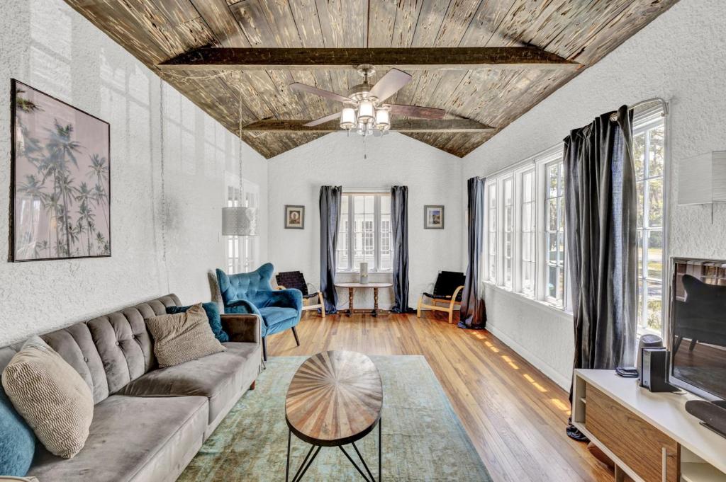a living room with a couch and a ceiling fan at 3br 1bath - Spanish Beach Bungalow MainHouse in Daytona Beach