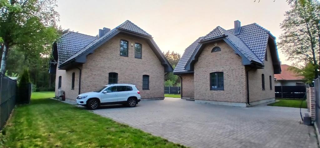 a white car parked in front of a house at Villa by the Baltic Sea in Palanga