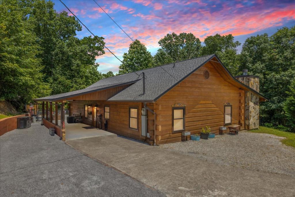 a large wooden cabin with a gambrel roof at Chasing Cubs Cabin By Beyond Expectations in Sevierville