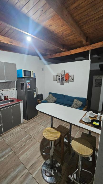 a kitchen with a table and chairs in a room at Caleta Olivia Ancla alojamiento departamento in Caleta Olivia