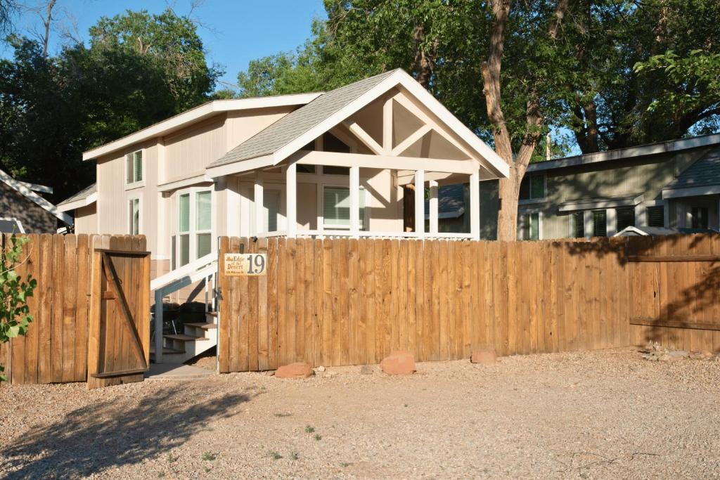 a wooden fence in front of a house at Canyonlands Cabin #19 in Moab