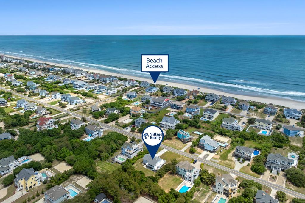 an aerial view of a beach with houses and the ocean at Wishing Whale in Corolla