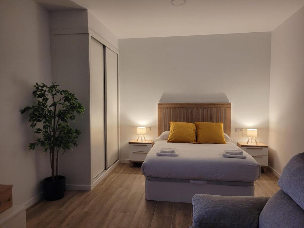 Ένα ή περισσότερα κρεβάτια σε δωμάτιο στο Apartamentos AbAc