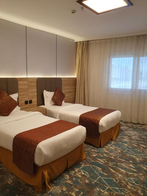 Postel nebo postele na pokoji v ubytování Sadeem Al Fajr Hotel Suites