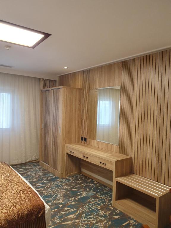 Postel nebo postele na pokoji v ubytování Sadeem Al Fajr Hotel Suites