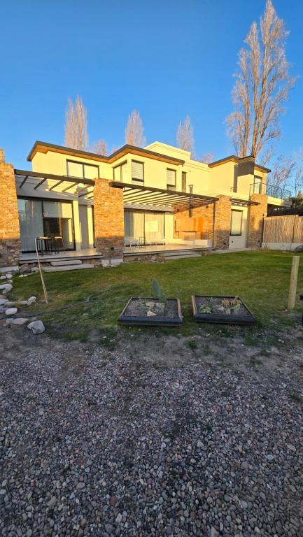 a house with two trays in front of it at Casa Reserva Vip in Ciudad Lujan de Cuyo