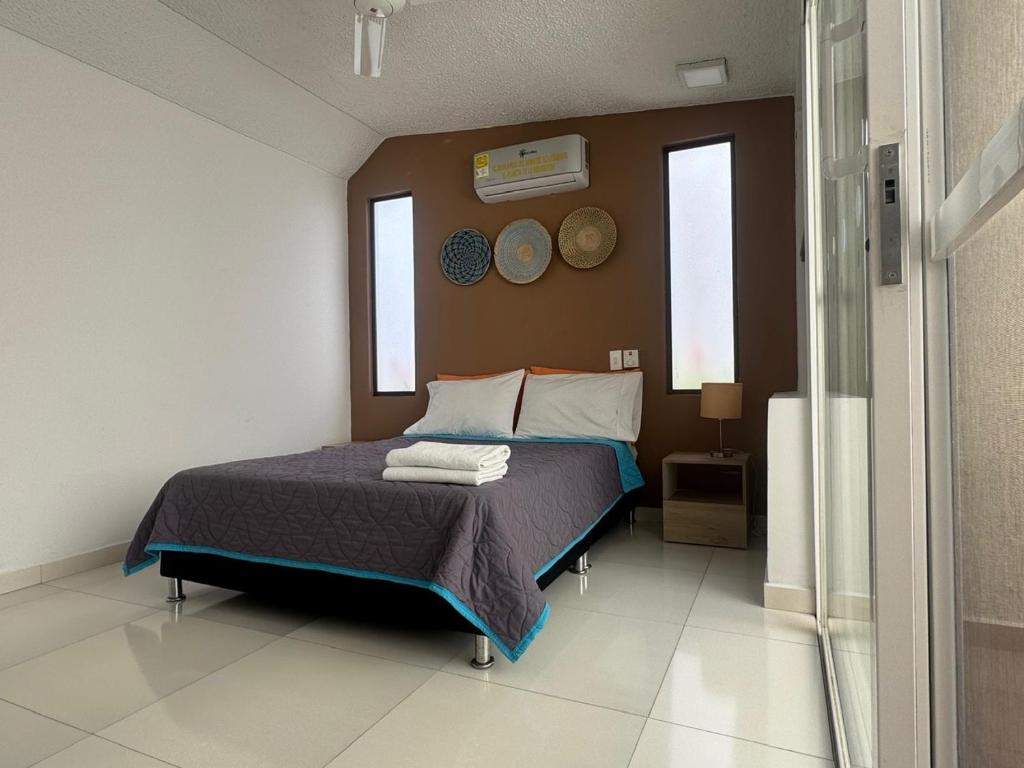 Postel nebo postele na pokoji v ubytování Hotel TACALOA INN EXPERIENCE