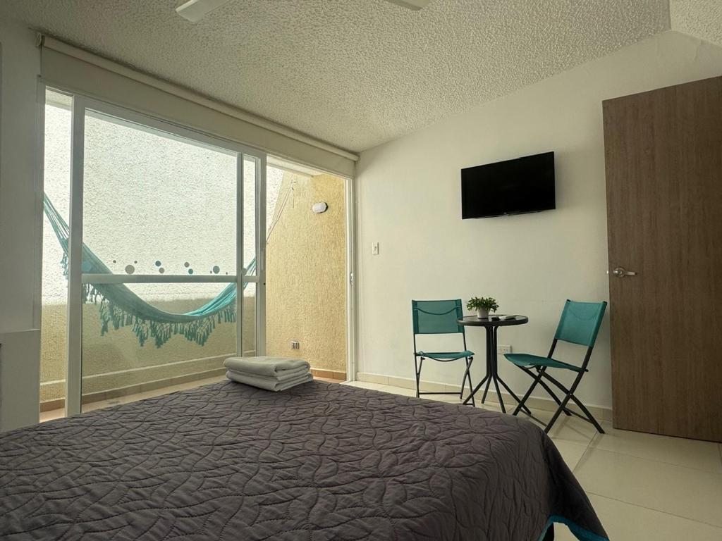 TV a/nebo společenská místnost v ubytování Hotel TACALOA INN EXPERIENCE