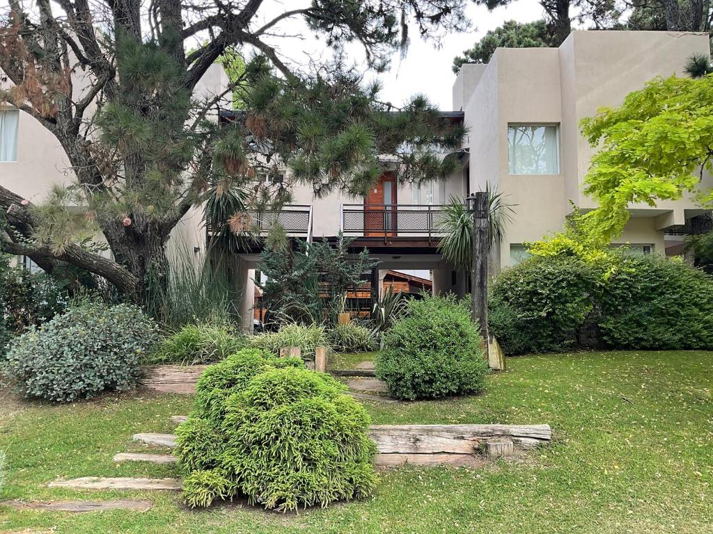 a house with a garden in front of it at Pax Costa del Este in Costa del Este