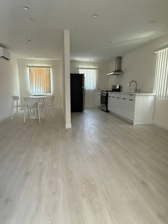 an empty room with a kitchen and a table in it at San Marino guest house in Los Angeles