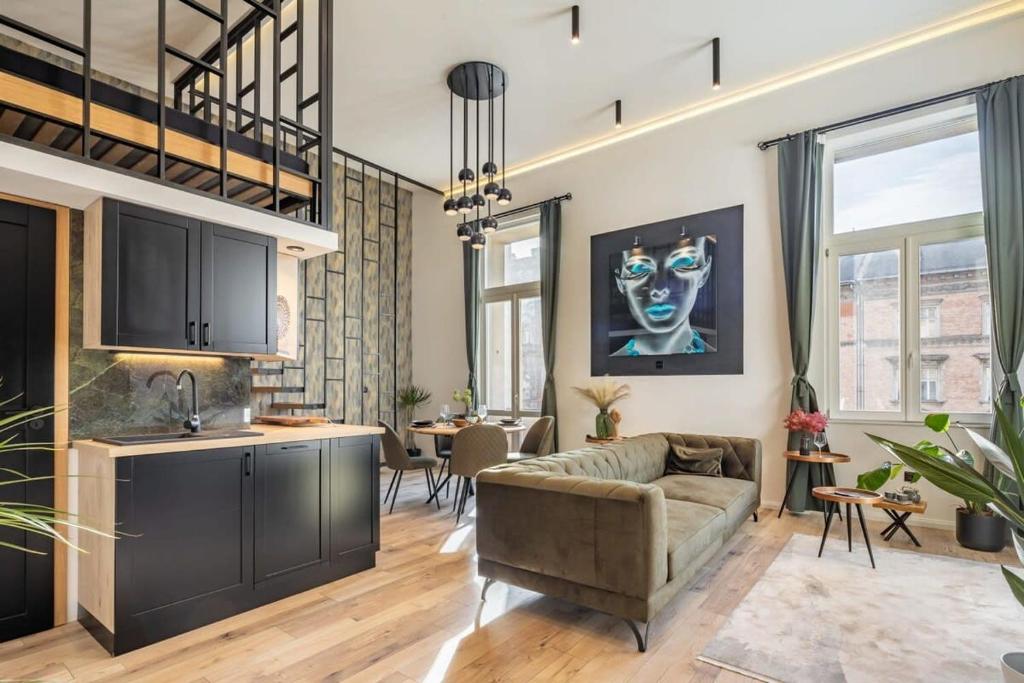 a living room with a couch and a kitchen at Central - Unique - High-End - Brand New in Budapest