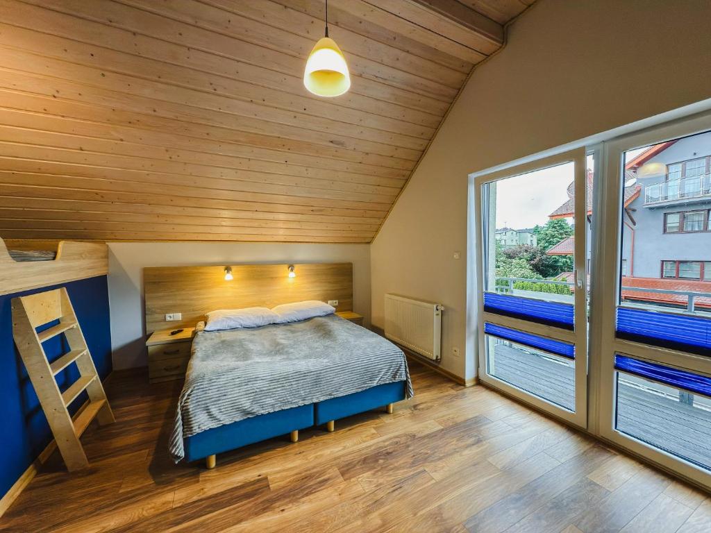 Posteľ alebo postele v izbe v ubytovaní Rellim Apartamenty