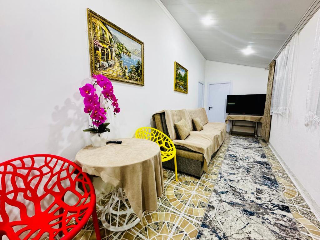 a living room with a couch and a table at Mansard 91 in Sergeli Bekati