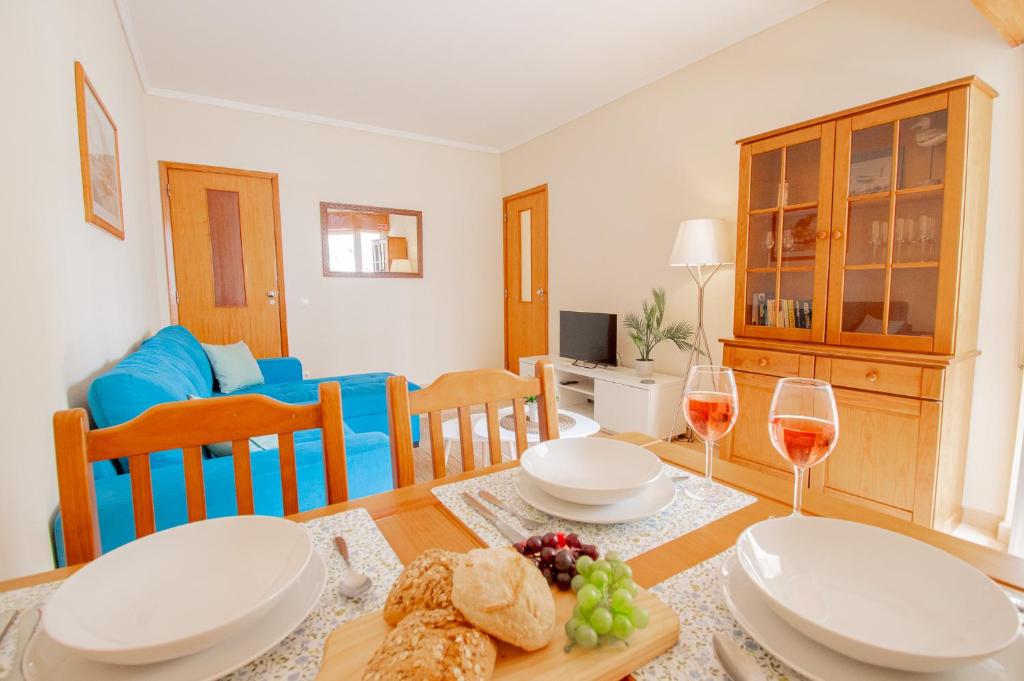 a dining room with a table with glasses of wine at Casa Ocean Breeze, Two bedrooms, 100m from the beach! in Portimão