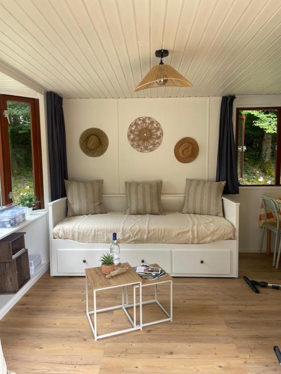 a bedroom with a bed and a coffee table at Cottage au calme Camping Les Tourterelles in La Celle-sous-Gouzon