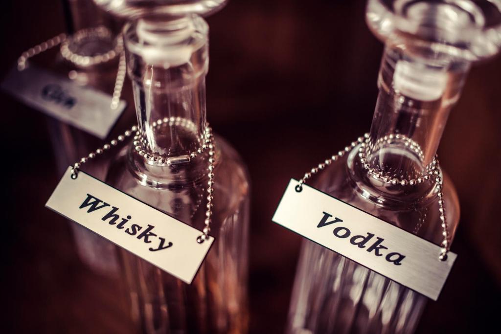 two glass bottles with words that say thirst and vodka at Carlton George Hotel in Glasgow