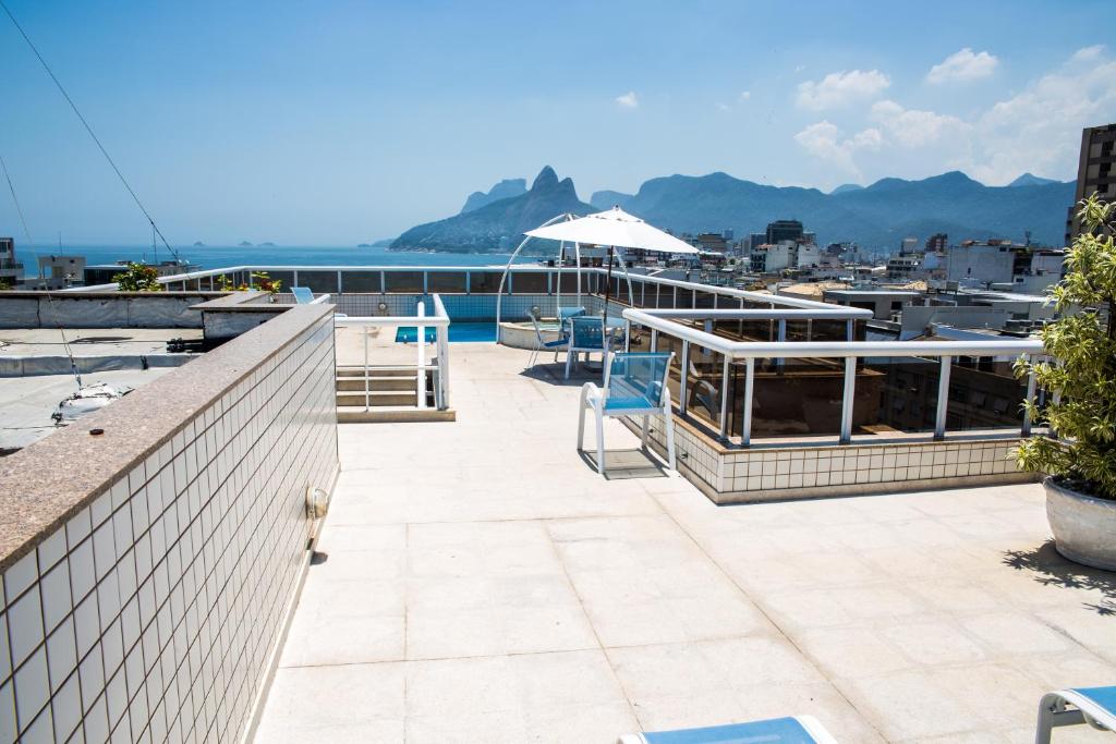 a patio with chairs and a view of the water at Atlantis Copacabana Hotel in Rio de Janeiro