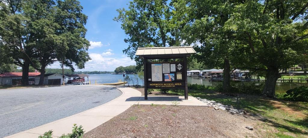 a sign on the side of a road next to a street at Gateway to Lake Tillery Retreat in Norwood