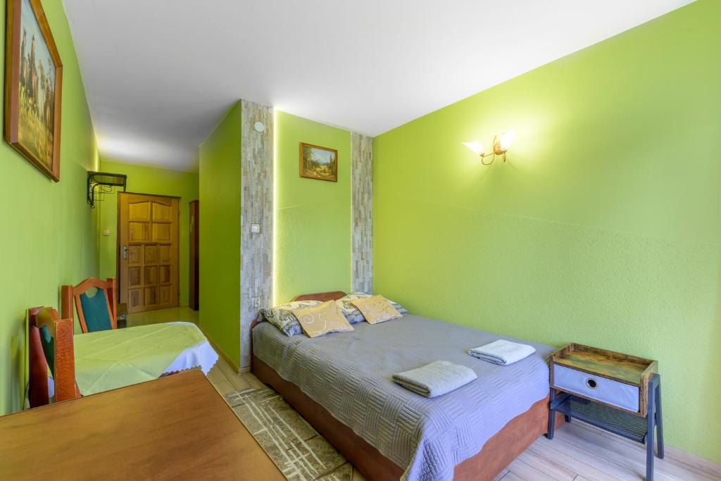 Posteľ alebo postele v izbe v ubytovaní Pokoje Gościnne U Babci