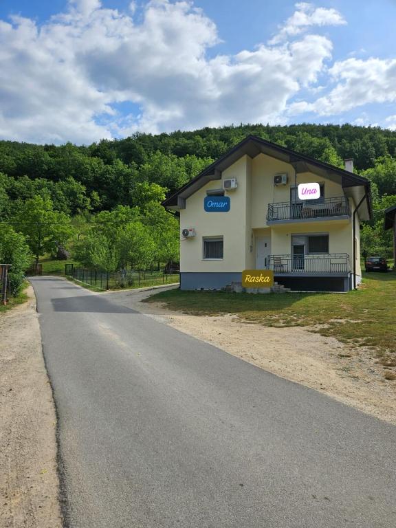 a building on the side of a road at Omar, Una & Raska Apartmani in Bihać