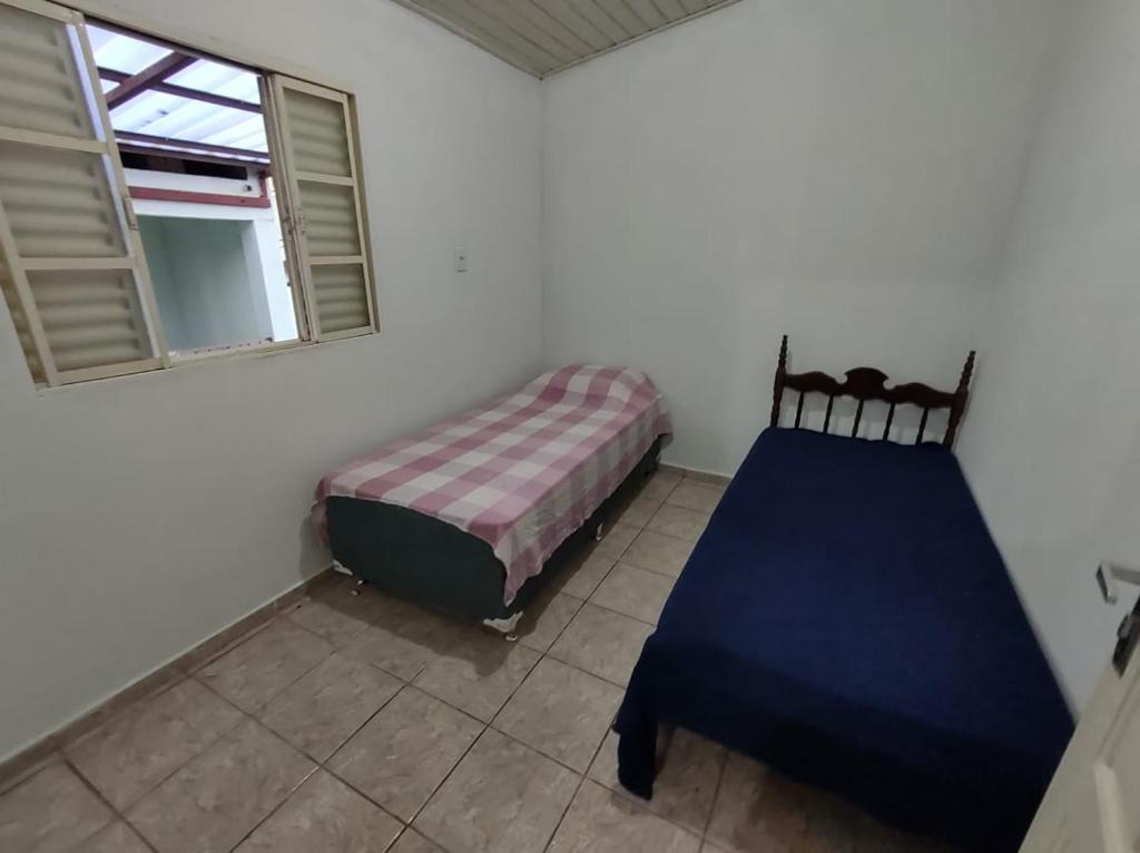 a bedroom with a bed and a window at República Minas Novas in Ouro Preto