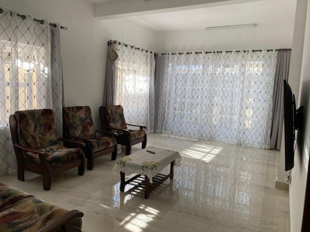 a living room with two chairs and a coffee table at Maison de Pagoda in Port Louis
