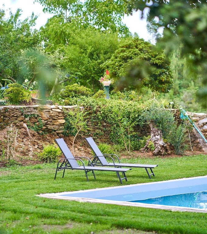 two lounge chairs sitting next to a swimming pool at Sky House by Everkind in Viana do Castelo