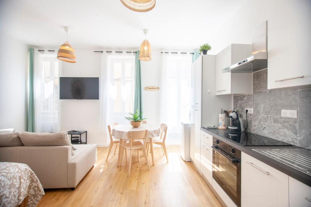 a kitchen and living room with a table and a couch at Providencia 3 - Shipyard and Yacht crews in La Ciotat