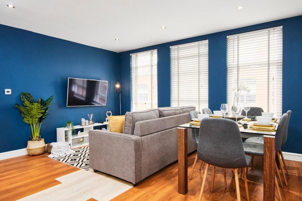 a living room with a couch and a table at Park Square Apartments Leeds in Central Station