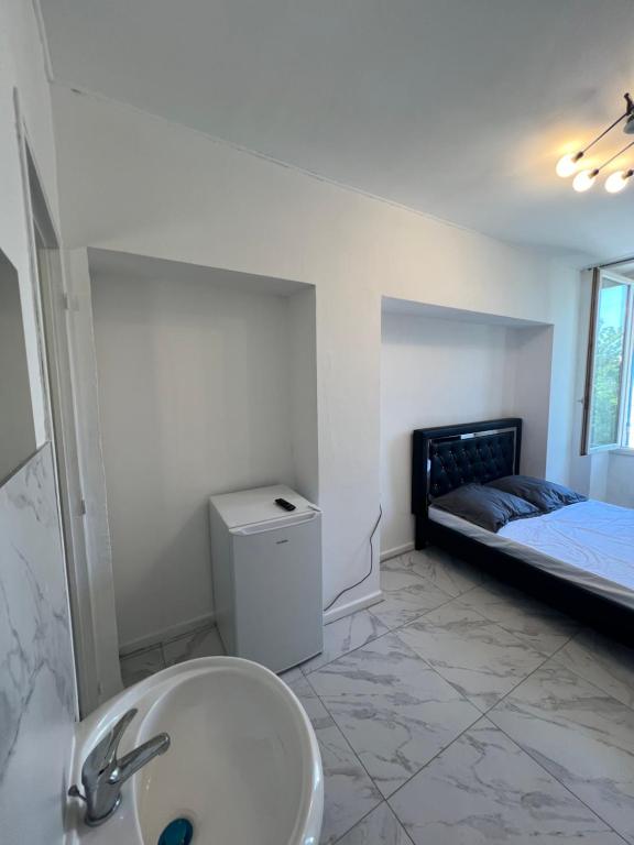 Un baño con lavabo y cama. en Casa Bianca, en Marsella