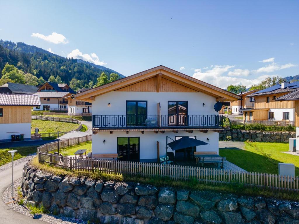 a house in a village with a stone wall at Obermöschach 10B in Obermöschach