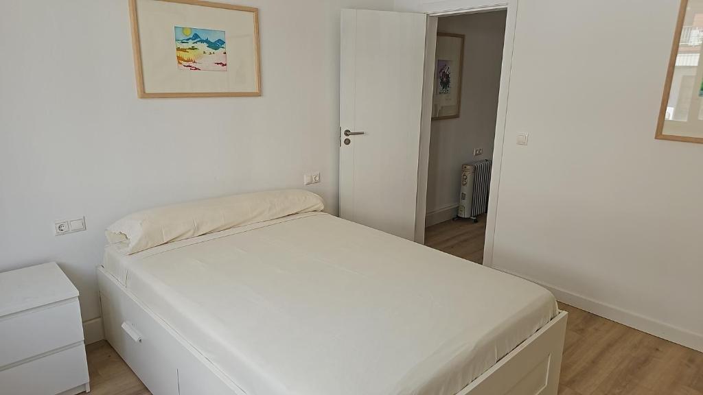 En eller flere senge i et værelse på Apartamento acogedor