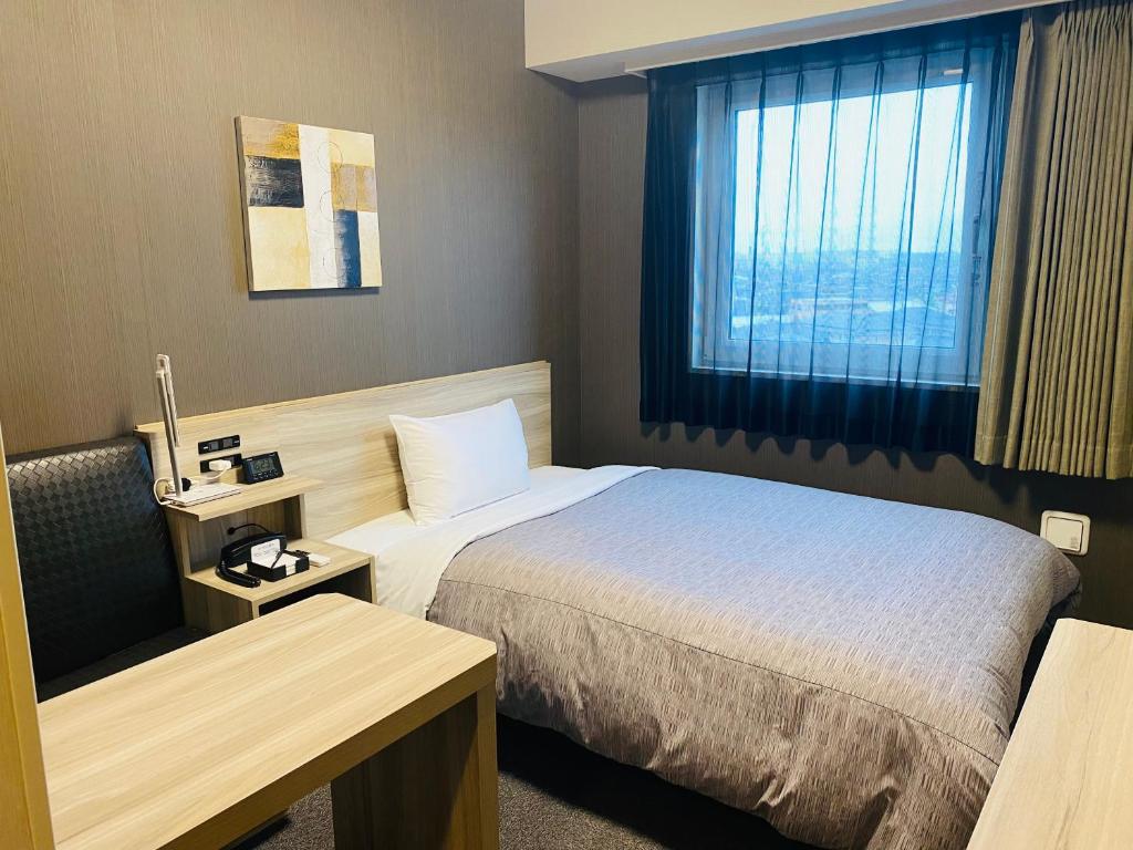 Postel nebo postele na pokoji v ubytování Hotel Route-Inn Ichihara