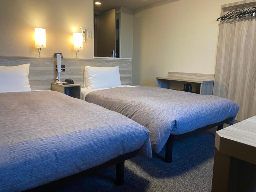 Postel nebo postele na pokoji v ubytování Hotel Route-Inn Ichihara